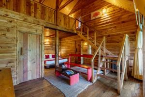 a room with a bunk bed and stairs in a log cabin at Alaya Stays Duplex Cottage with Tree House - Suro Woodcrest Chalet in Shogi