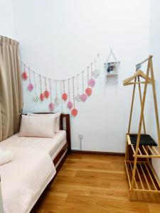 a room with a bed and a string of ornaments at CupidWood Residensi Ostia Bangi with Pool free NEFLIX, Wifi, Parking in Bandar Baru Bangi
