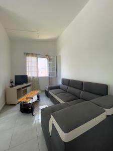 a living room with a couch and a table at Villa trinité in La Trinité