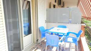 a patio with a table and chairs on a balcony at Friends House - Borsh Hotel in Borsh