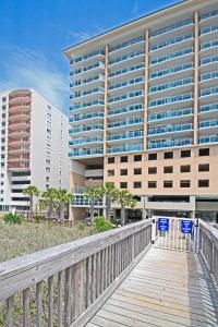 a wooden boardwalk leading to a large building at Bahama Sands Condos in Myrtle Beach