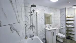 a bathroom with a shower and a toilet and a sink at INNit Joy in Brighton & Hove +35 photos