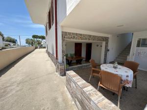 a patio with a table and chairs on a building at THE FLOWER APARTMENTS in Toroni