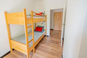 a bunk bed in a room with a ladder at New & cozy apartment by the Park in Chorzów