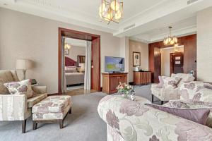 a living room with a bed and a couch and a tv at Fota Island Hotel and Spa in Fota Island