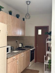 a kitchen with wooden cabinets and a stove top oven at Kyel location in Ashdod