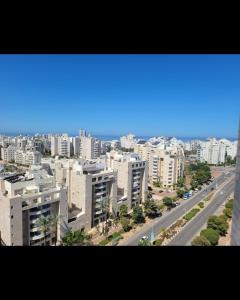 an aerial view of a city with buildings and a road at Kyel location in Ashdod