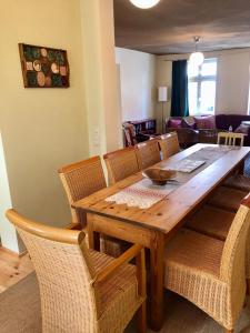 a dining room with a wooden table and chairs at Das Brunnenhaus in Tangermünde