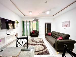 a living room with a couch and a table at Haven Villa in Apowa