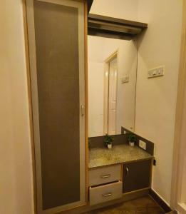 a bathroom with a sink and a large mirror at Flickstays Acacia in Bangalore +27 photos