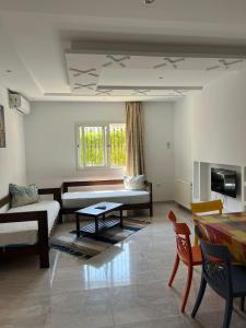 a living room with a couch and a table at Residence Trust in Sousse