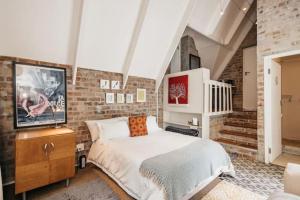 Ένα ή περισσότερα κρεβάτια σε δωμάτιο στο The Loft at 33