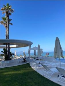 a group of chairs and umbrellas on a beach at Bungalow de lujo 5* 1ª LÍNEA Playa San Juan in Alicante