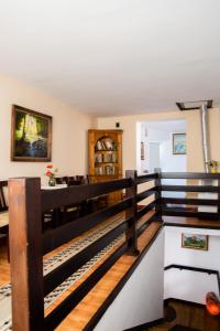 a living room with a wooden railing in a house at Panorama Guesthouse in Sighişoara