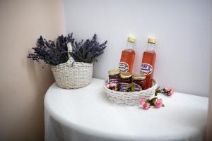 a table with two bottles of honey and a basket of flowers at Panorama Guesthouse in Sighişoara