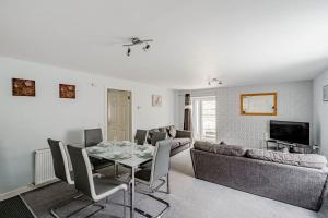 a living room with a table and a couch at Auchenlarie Courtyard No 3 in Gatehouse of Fleet