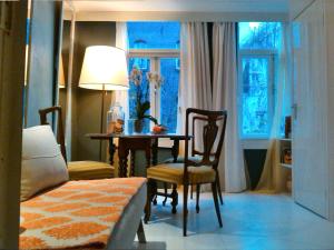 a bedroom with a table and chairs and a window at Miss Jordaan for Quiet Travellers in Amsterdam