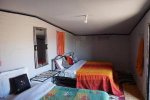 A bed or beds in a room at Chegaga Desert Trips