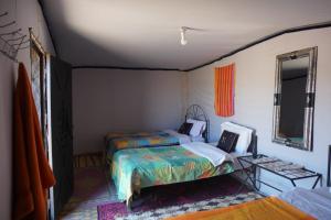 A bed or beds in a room at Chegaga Desert Trips