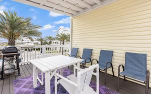 a white table and chairs on a deck with a grill at Seaclusion by Oversee 30A in Inlet Beach +10 photos