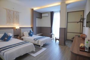 Postel nebo postele na pokoji v ubytování Amy Hotel