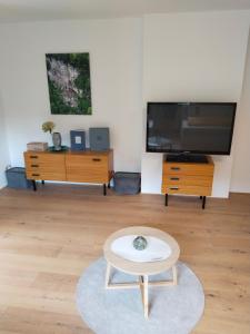 a living room with a tv and a coffee table at am Fluhbach in Mellau