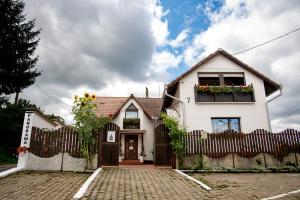 a white house with a fence and flower boxes at Panorama Guesthouse in Sighişoara