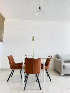 a dining room with a table and chairs at Villa Saarchi Apartments in Windhoek