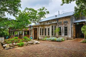 an old house with a garden in front of it at Gruene Retreat in New Braunfels
