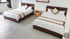 Postel nebo postele na pokoji v ubytování Vy An Hotel