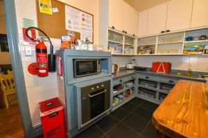 a kitchen with a stove and a table in it at No14 Lovel St in Katoomba