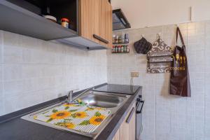 a kitchen with a sink with a towel on it at Casa Intersimone in Pachino +12 photos