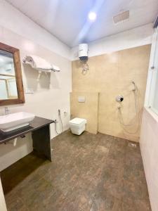 a bathroom with a sink and a toilet at Magic Sand Beach Resort in Arambol