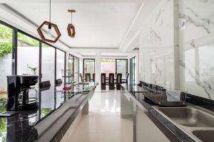 a kitchen with marble counter tops and glass counters at CASA VS Casa nueva con alberca jacuzzi y jardín in Gallinero