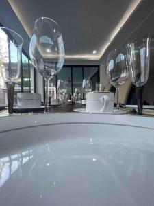 a bathroom with wine glasses and a bath tub at CASA VS Casa nueva con alberca jacuzzi y jardín in Gallinero