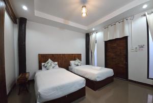 Postel nebo postele na pokoji v ubytování Sabai d hotel Chiang Rai สบายดีโฮเทล