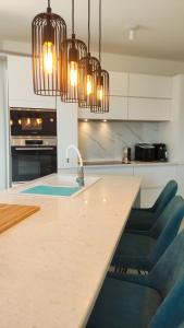 a kitchen with a sink and a counter with chairs at Zavala Residence in Zavala