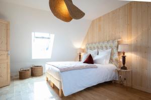 a bedroom with a white bed with a wooden wall at Casa Pertica in Ceton +51 photos