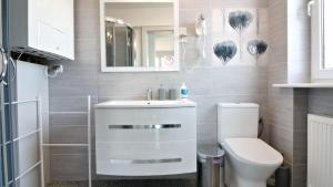 a bathroom with a white sink and a toilet at LC pokoje & apartamenty B52 in Szczecin +27 photos