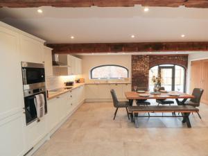 a kitchen and dining room with a wooden table at The Mill House in Thirsk