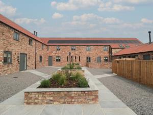 an external view of a brick building with a courtyard at The Mill House in Thirsk