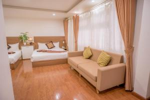 Rúm í herbergi á Sky House Hotel Da Lat City