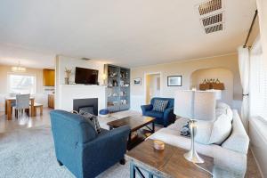 a living room with a couch and chairs and a fireplace at Hallie House MCA 314 in Manzanita