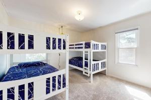 a bedroom with two bunk beds and a window at Hallie House MCA 314 in Manzanita