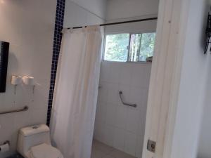 a bathroom with a shower with a toilet and a window at Campestre el Salitre Villeta in Villeta +18 photos