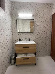 a bathroom with a sink and a mirror at Casa Vladeasa in Caciulata