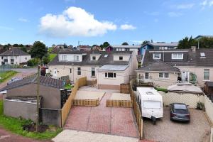 an aerial view of a house with a van parked in a driveway at Diamond House - 4 bedroom luxury home in Airdrie