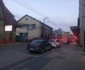 a city street with cars parked on the street at Departamento Edificio Centro Osorno in Osorno