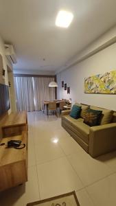 a living room with a couch and a table at Vista Piscinas - Park Veredas 417 in Rio Quente