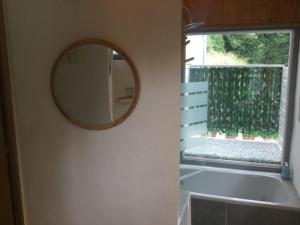 a mirror on a wall next to a window at Casa Jardín Rocablanca Llanes in Celorio +37 photos